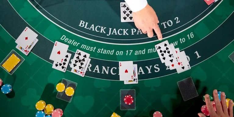 Black Jack Tisch von oben mit Hand des Dealers, der Karten ausgibt