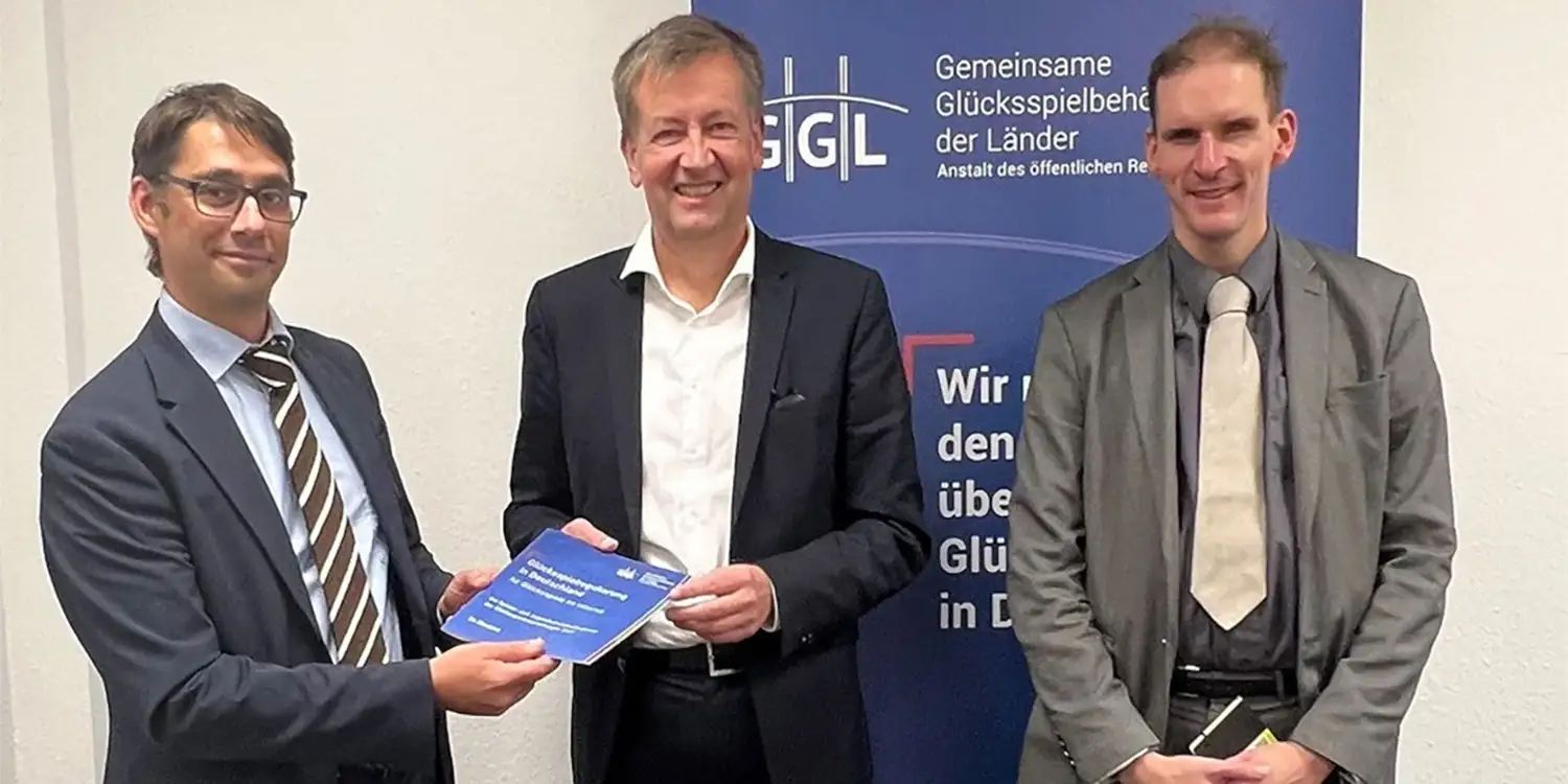 Burkhard Blienert wird die neue Broschüre der GGL überreicht