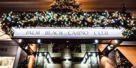 Weihnachtlich dekoriertes Eingangsschild mit dem Schriftzug "Palm Beach Casino Club"